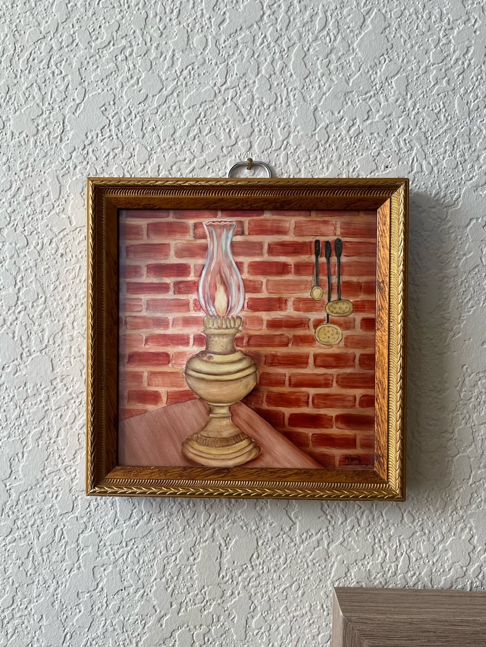 Vintage Decorative wall tile depicting oil lamp, brick wall and kitchen utensils